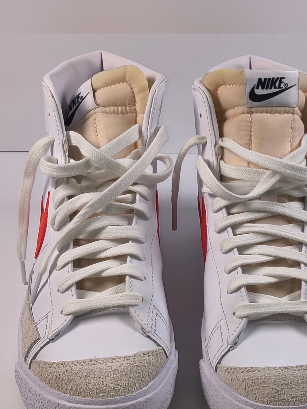 Nike Women's White High-Top Sneakers with Red Swoosh